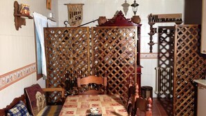 A traditional room with a wooden four-poster bed, a lace partition, and a tiled floor. - Casa Rural el Rincon del Infante (Villa de Don Fadrique)
