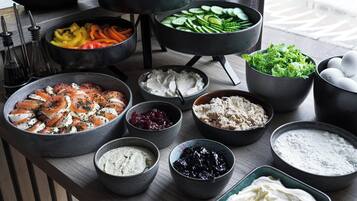 A variety of food items displayed on a table, including fruits, vegetables, and prepared dishes.