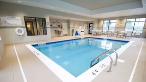 An indoor swimming pool with clear water, marked depth lines, and a lifeguard chair. - Hampton Inn Decatur Mt. Zion (Decatur)