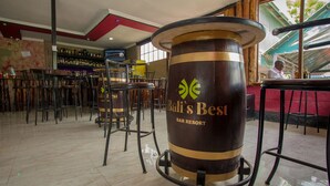 A bar area with a large wooden barrel labeled "Bali's Best Bar Resort" and multiple bar stools. - Balis Best Bar and Resort (Nairobi)