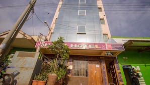A hotel with a sign reading "SHAMZ HOTEL" and a green building adjacent to it. - Shamz Hotel Isiolo (Isiolo)