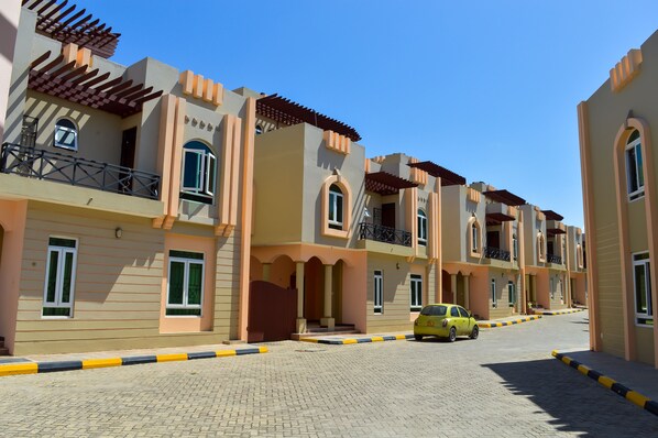 A row of modern apartment buildings with balconies and large windows.