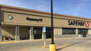 Ein Safeway Geschäft mit einer Apotheke, gekennzeichneten Parkplätzen und einem Parkplatz für Menschen mit Behinderung.