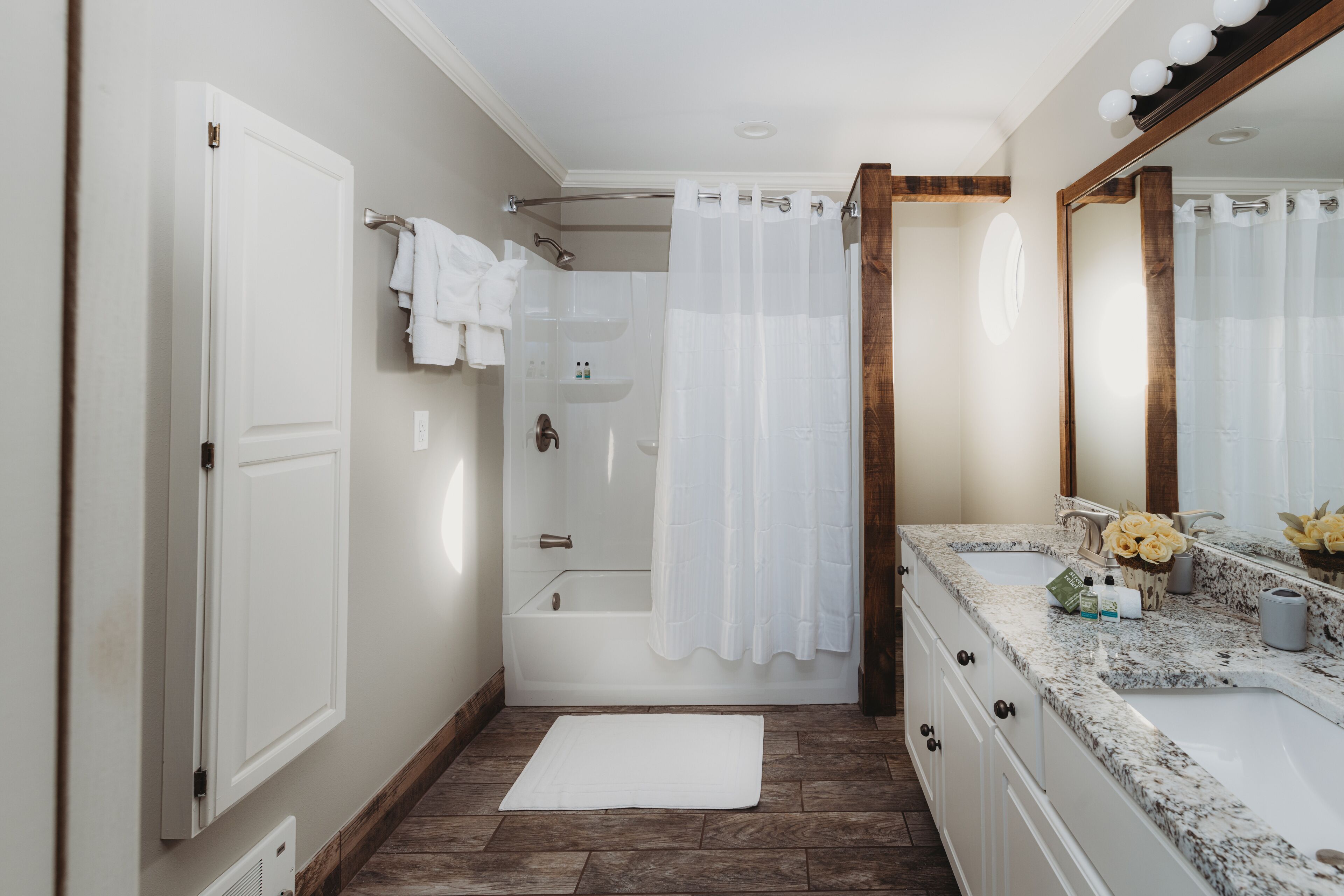 A bathroom with a bathtub, shower, and sink.
