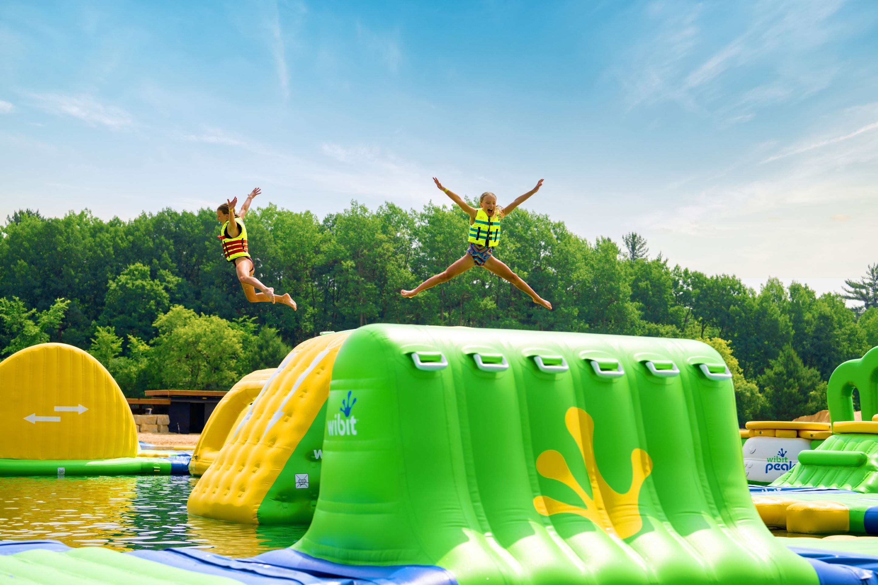 Inflatable water slides and pools in an outdoor setting.