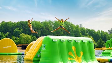 Inflatable water slides and pools in an outdoor setting.