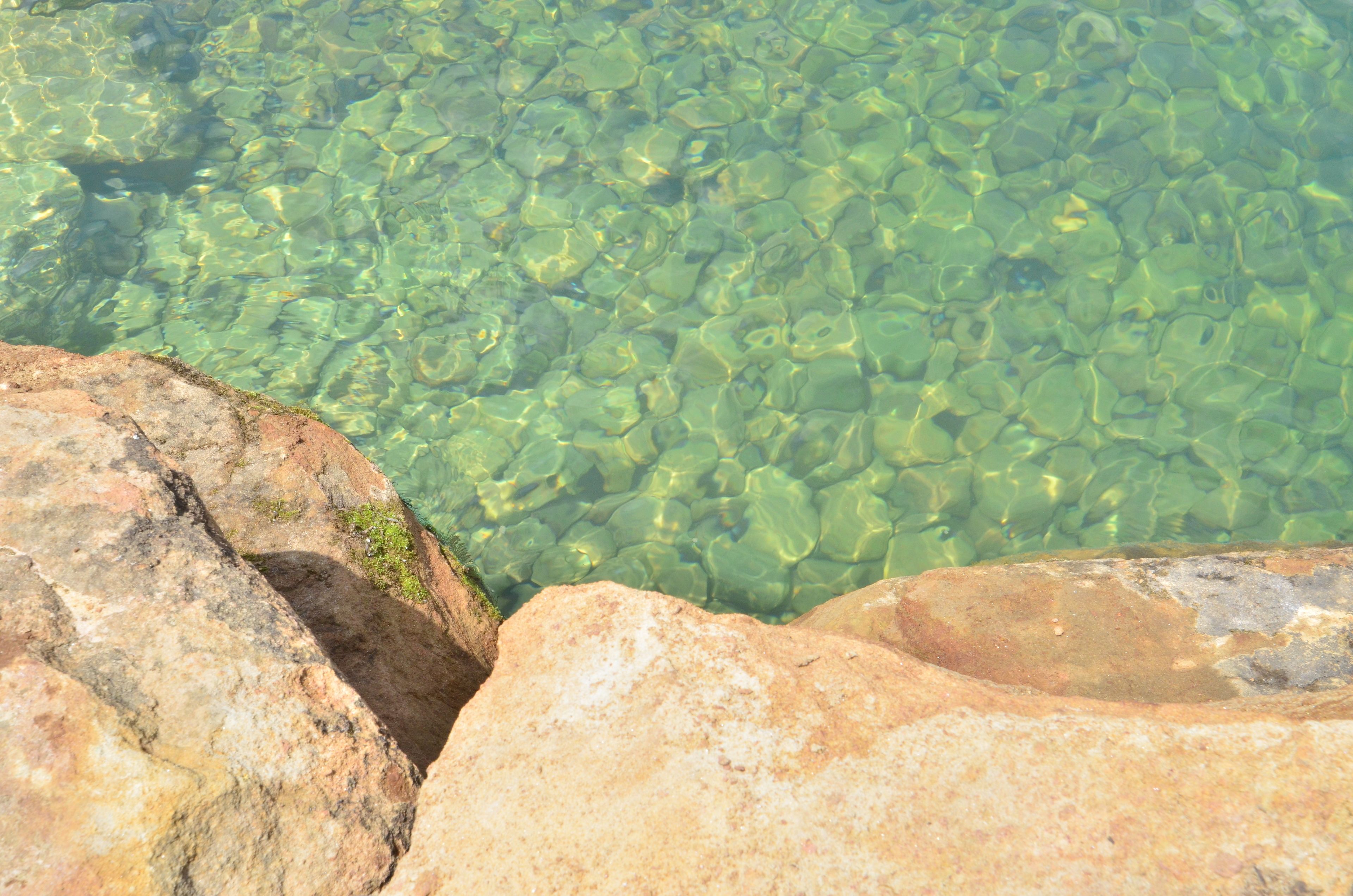 A clear view of a rocky shoreline with water.
