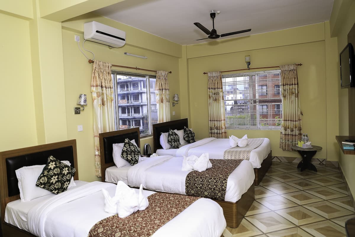 Deluxe Quadruple Room | Premium bedding, in-room safe, desk, laptop workspace