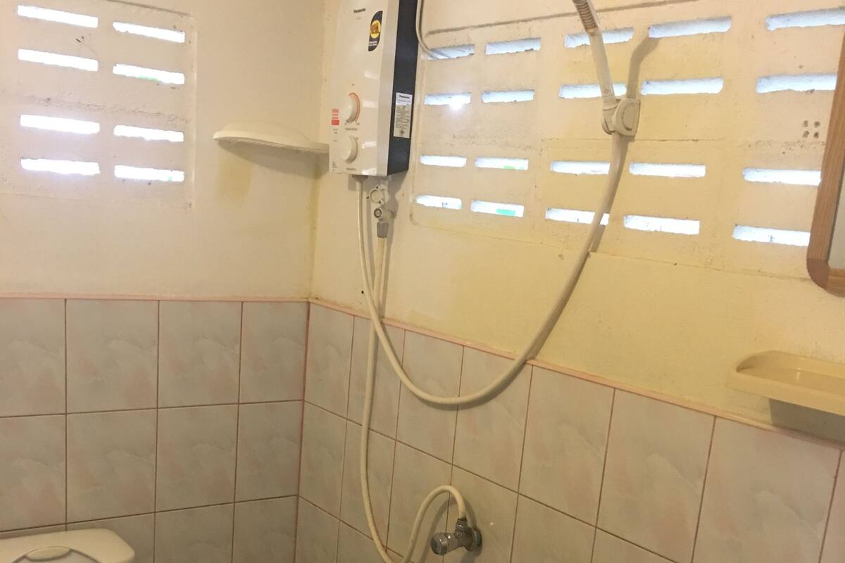 beach front bungalow | bathroom | shower, rainfall showerhead, towels, soap