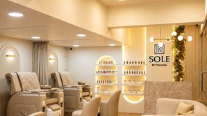 A spa with massage chairs, a reception desk, and shelves with products. - Thilhara Colombo (Colombo)