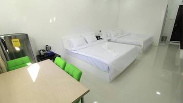A hotel room with a bed, a desk, and a chair.