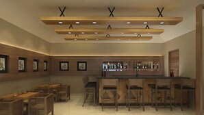 A modern bar area with wooden furniture and a bar counter. - Khuru Resort (Punakha)