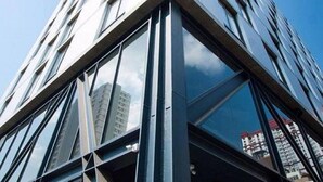 A modern building with a glass facade and a geometric design. - Klub Hotel (Bangkok)