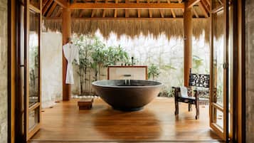 Relax in a serene space with a large water feature and a cozy bench.