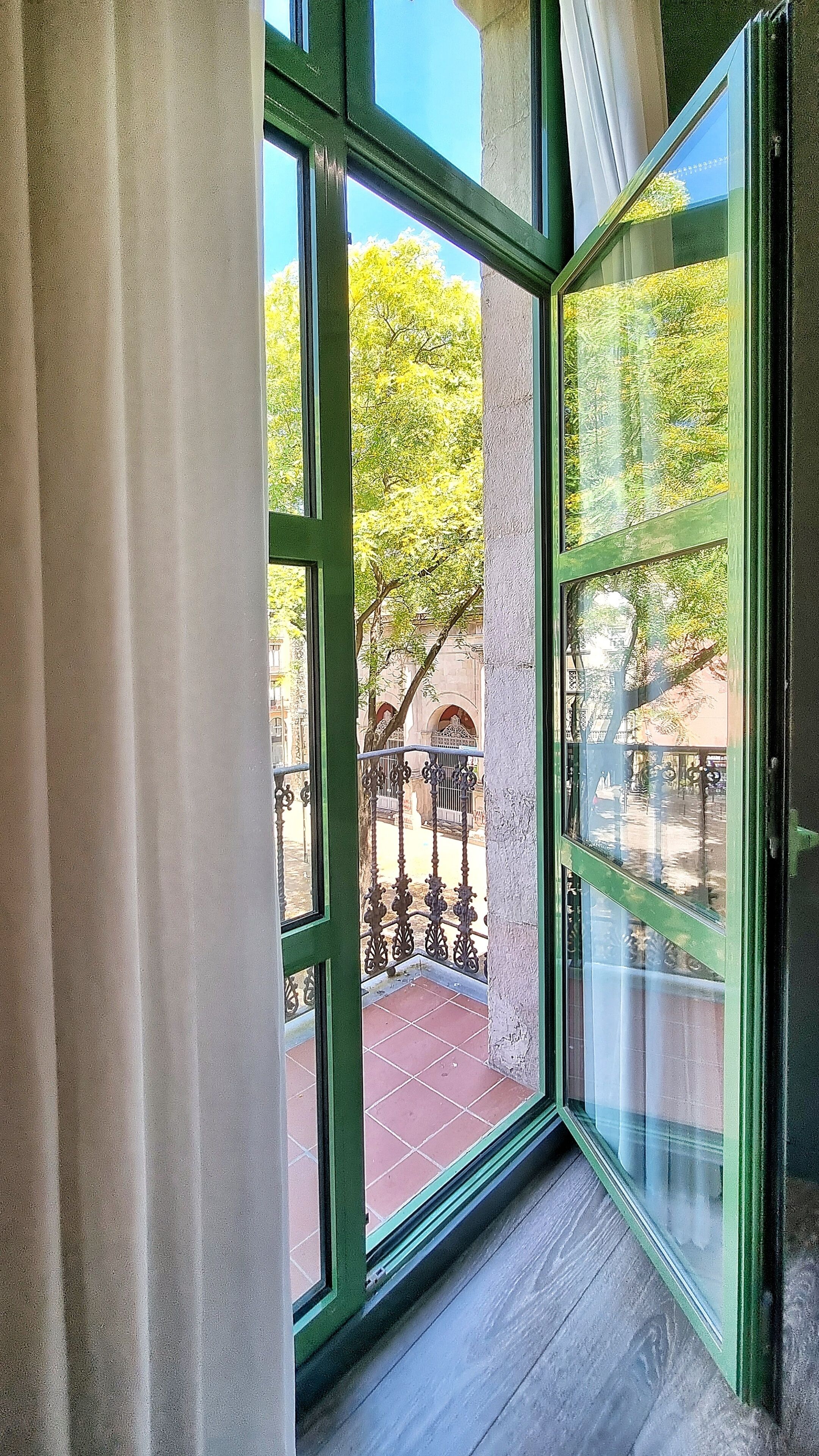 double exterior comfort room with square/street view | in-room safe, desk, laptop workspace, blackout curtains