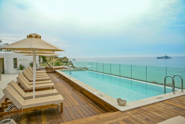 Outdoor pool, open 9:00 AM to 9 PM, pool umbrellas, pool loungers