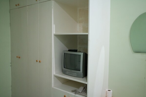 A white wardrobe with a television on the middle shelf. - Tourista's Place (Puerto Princesa)