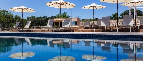 Outdoor pool, an infinity pool, pool loungers