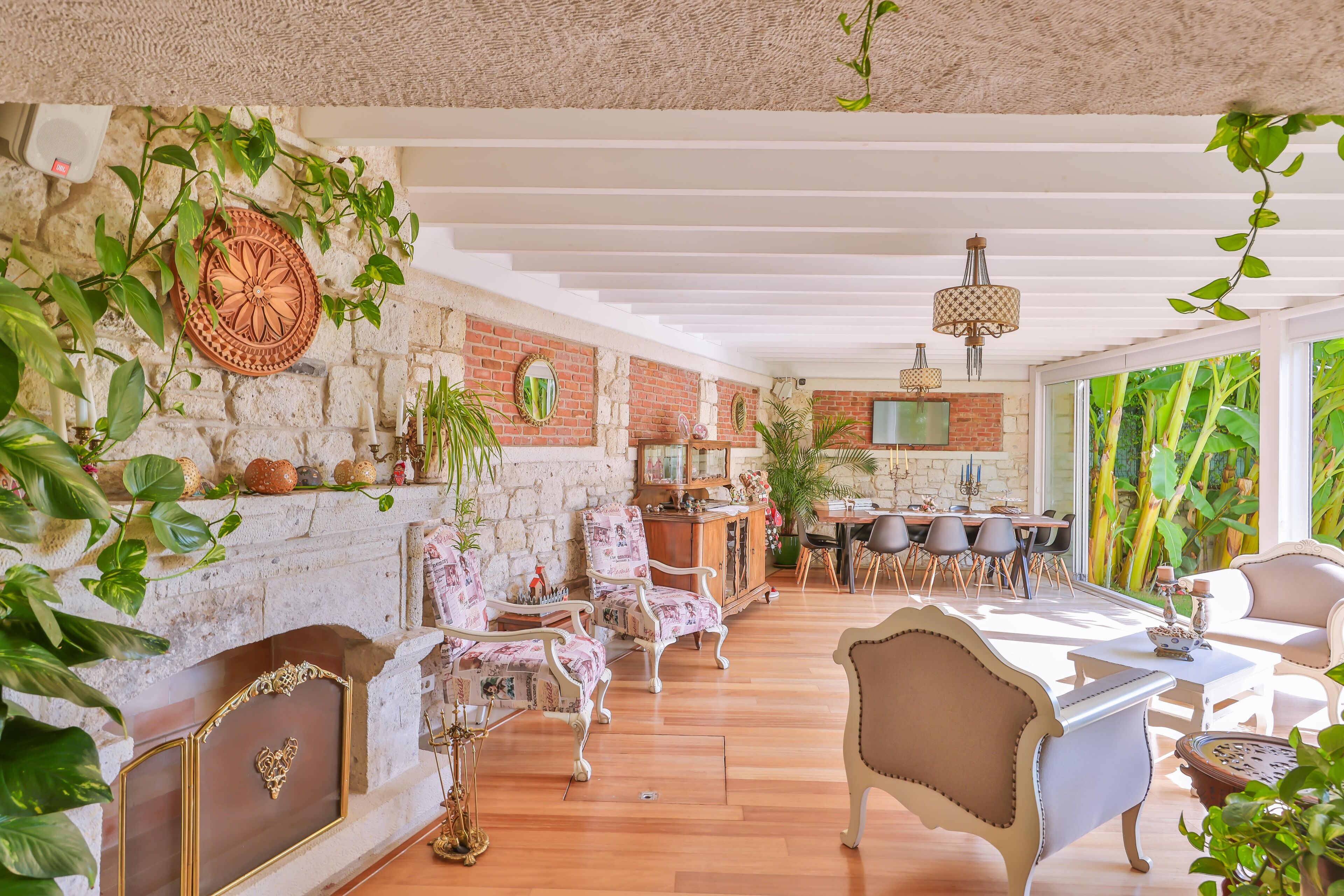 A spacious living room with a fireplace, a dining area, and a kitchen.