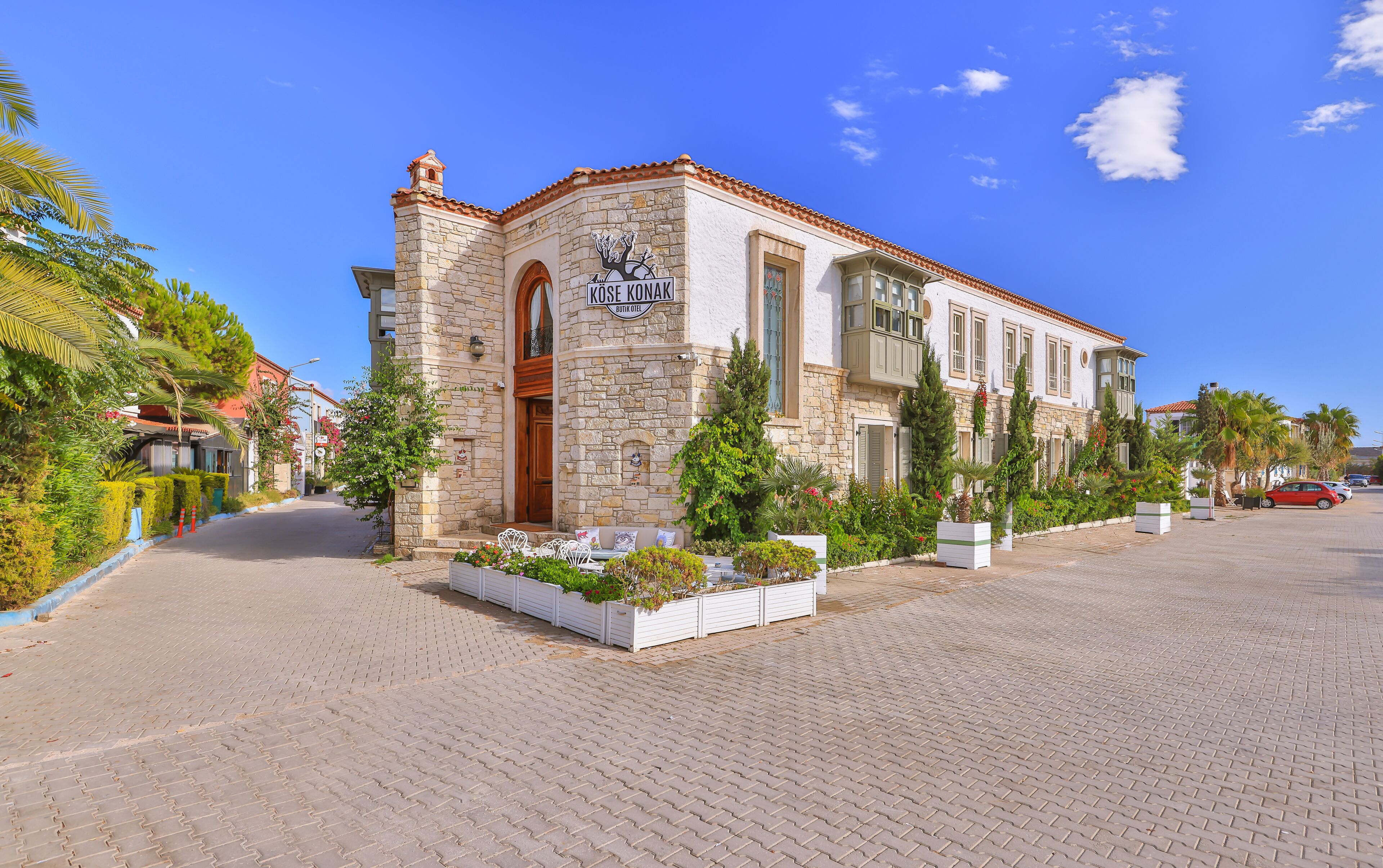 A stone building with a sign reading "Kuse Ronak Boutique Hotel".