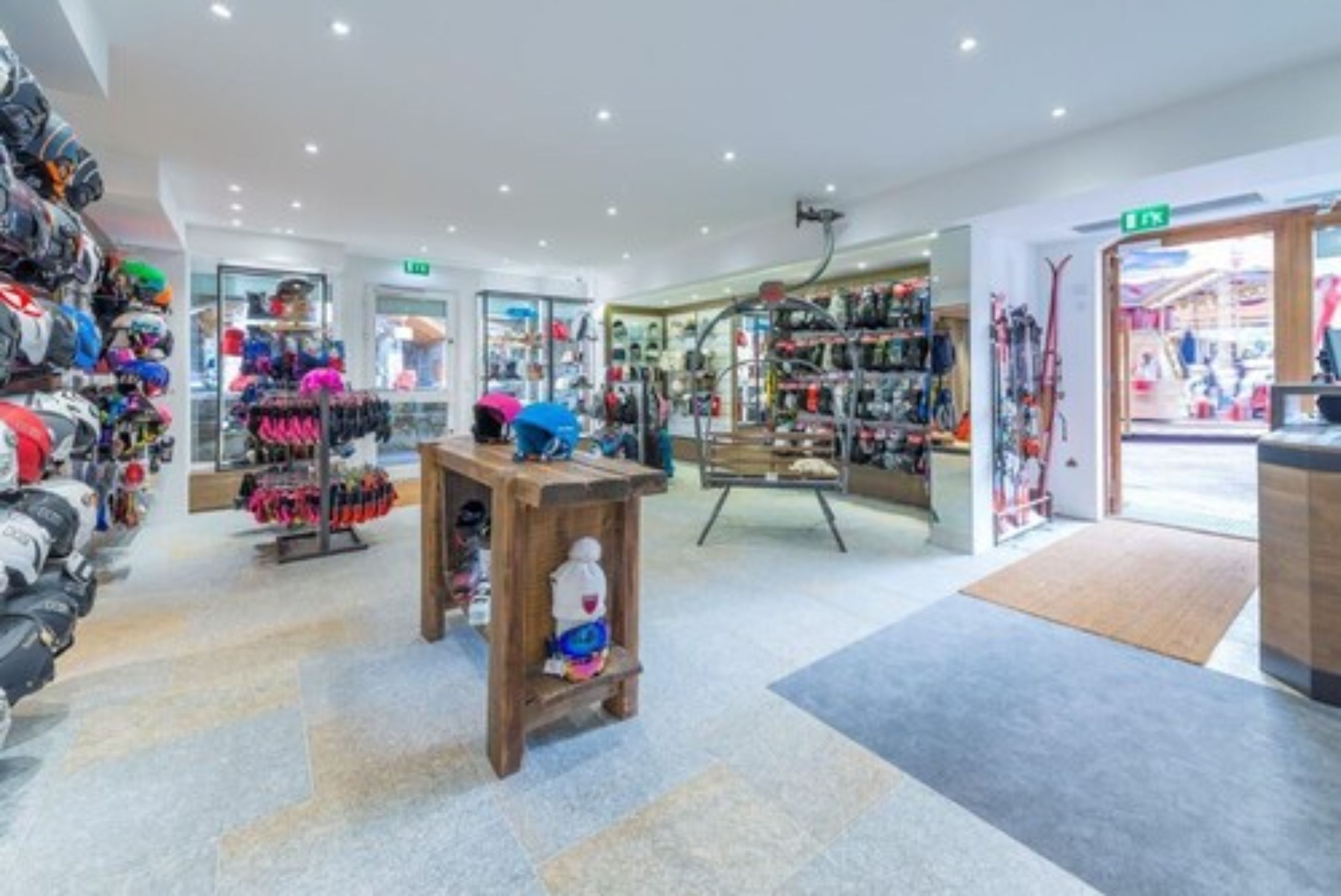 Interior de una tienda con diverso equipo y ropa deportiva a la vista.