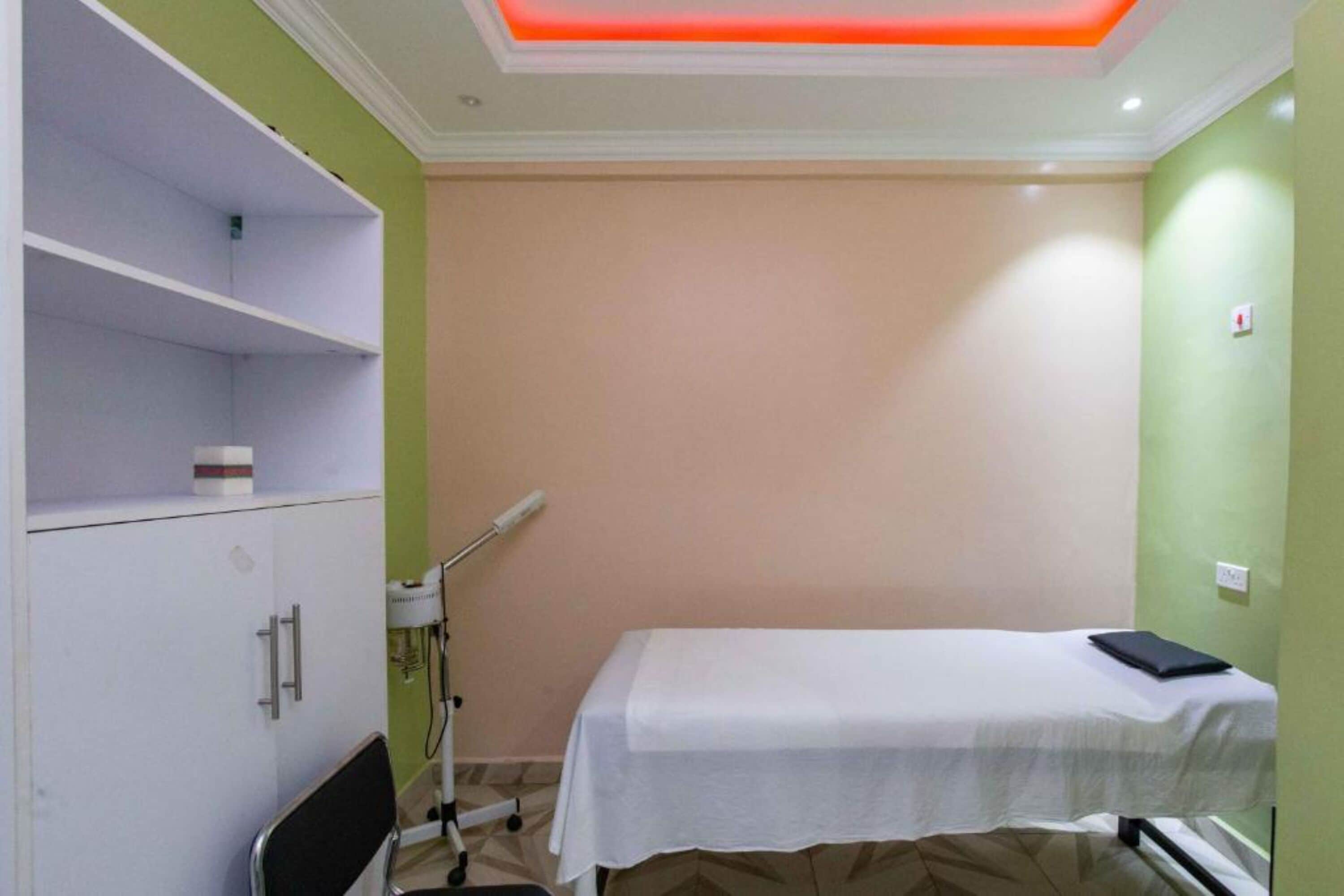 Un consultorio médico con una cama, un armario y un equipo médico.
