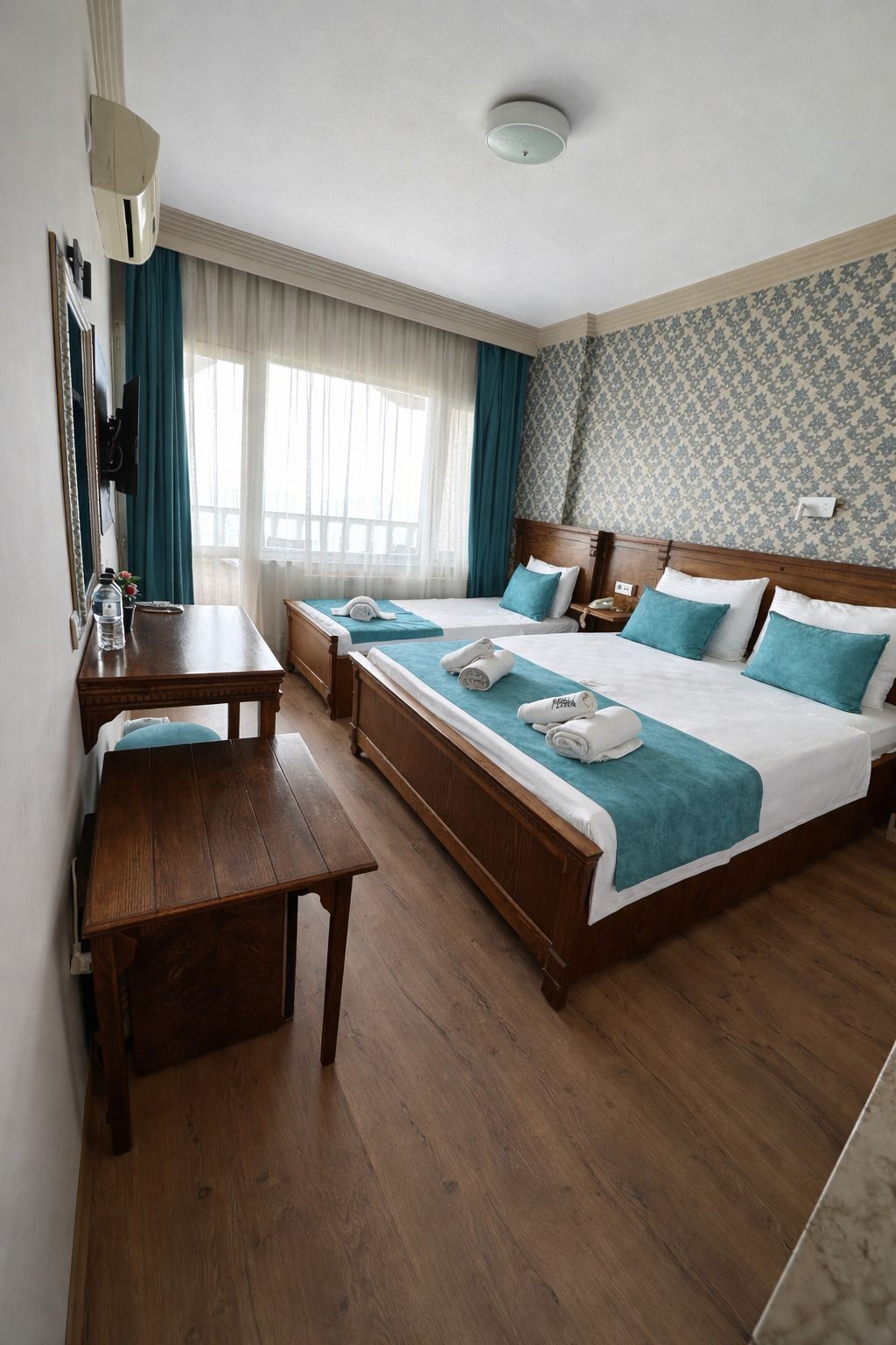 Standard Triple Room, Sea View | Minibar, in-room safe, iron/ironing board, free WiFi
