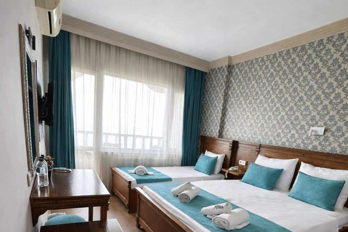 Standard Triple Room, Sea View | Minibar, in-room safe, iron/ironing board, free WiFi