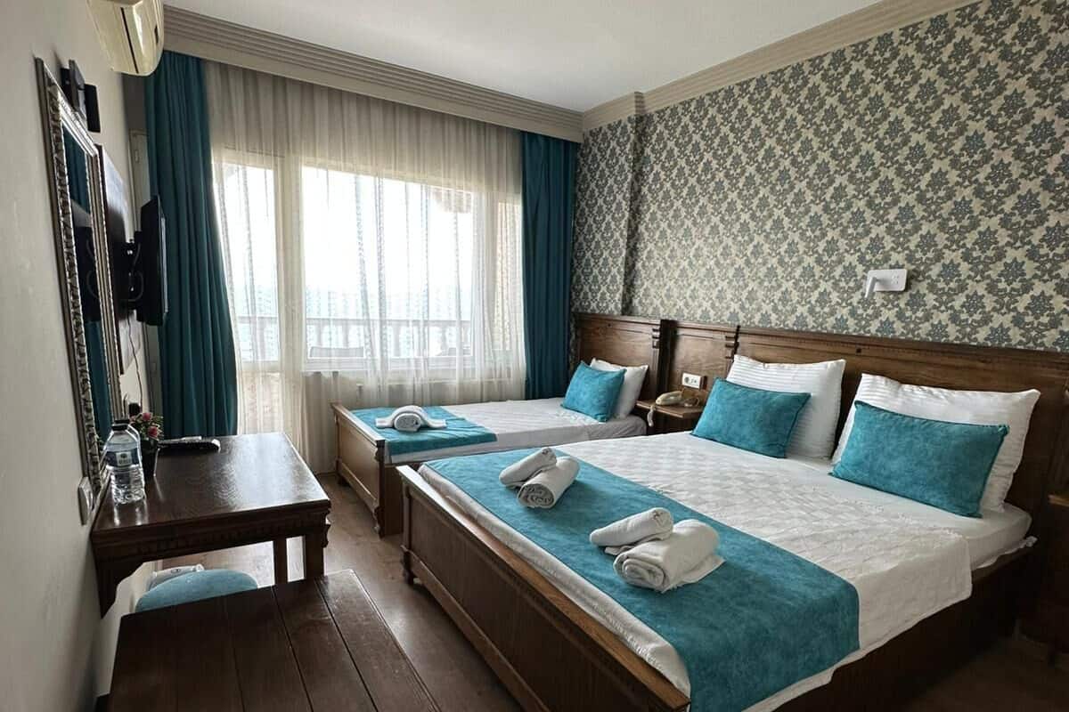 Standard Triple Room, Pool View | Minibar, in-room safe, iron/ironing board, free WiFi