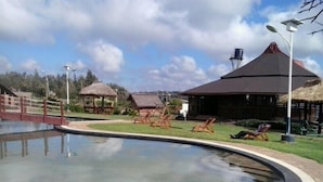 A swimming pool with lounge chairs and a gazebo. - Oloolua Resort & Campground (Ngong)
