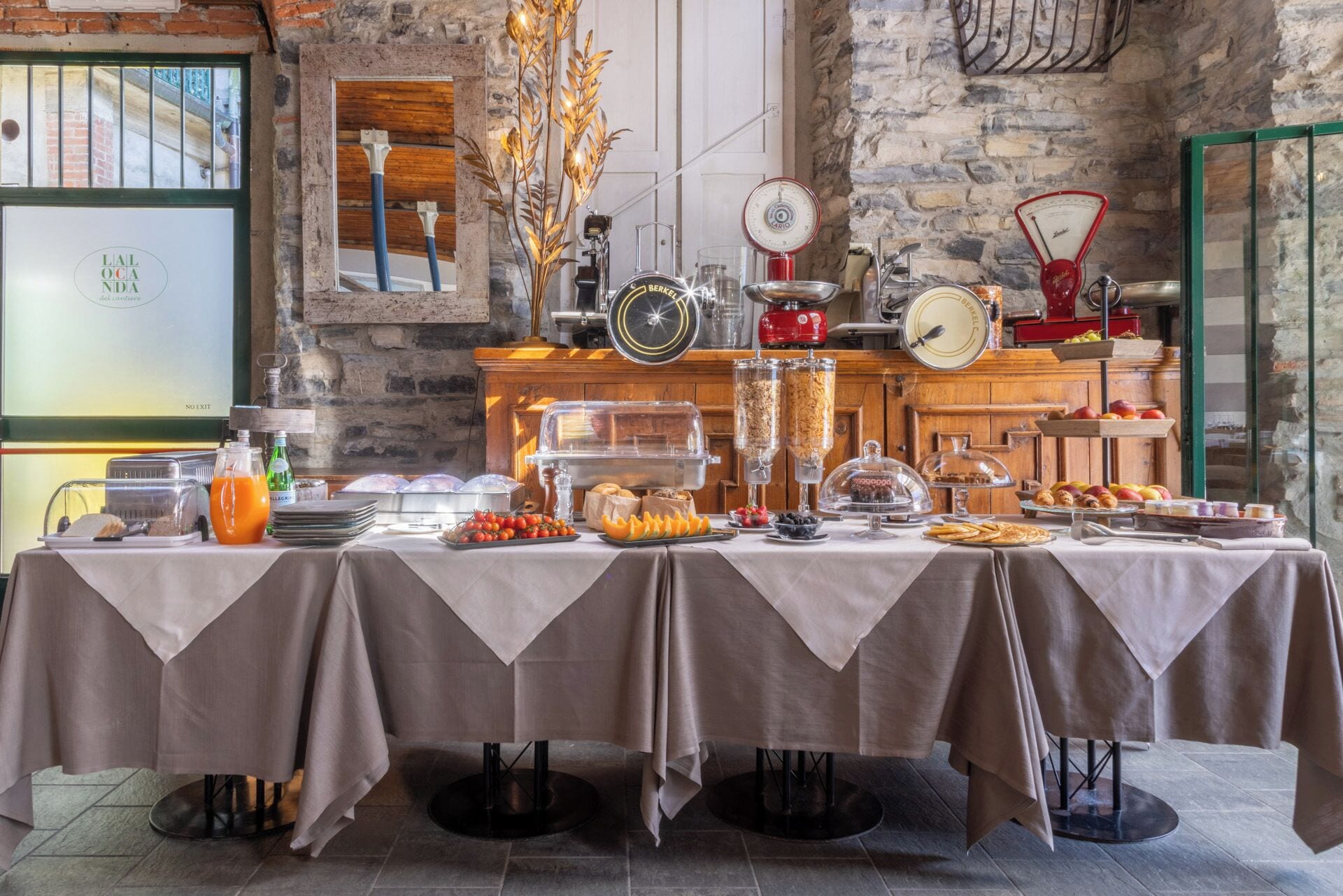 A breakfast buffet with various food items and serving equipment.