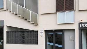A modern building with a staircase, a large window, and a door with a blue accent. - Avec Moi Roma (Rome)