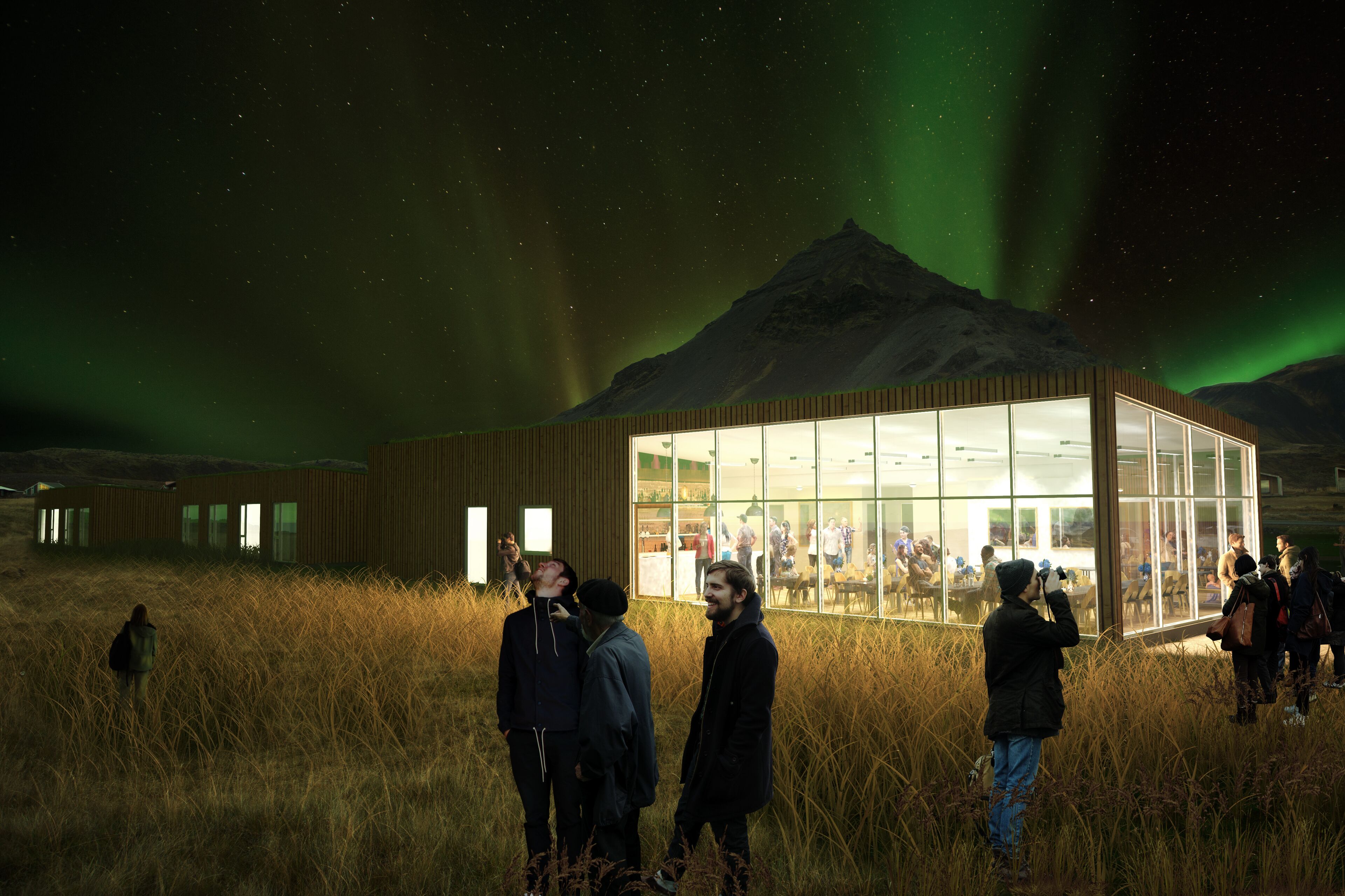 A building with large windows, a grassy field, and a mountain in the background.