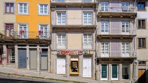 A multi-story building with balconies, a ground-floor shop, and a variety of window styles. - YOUROPO - ExtendALL (Porto)