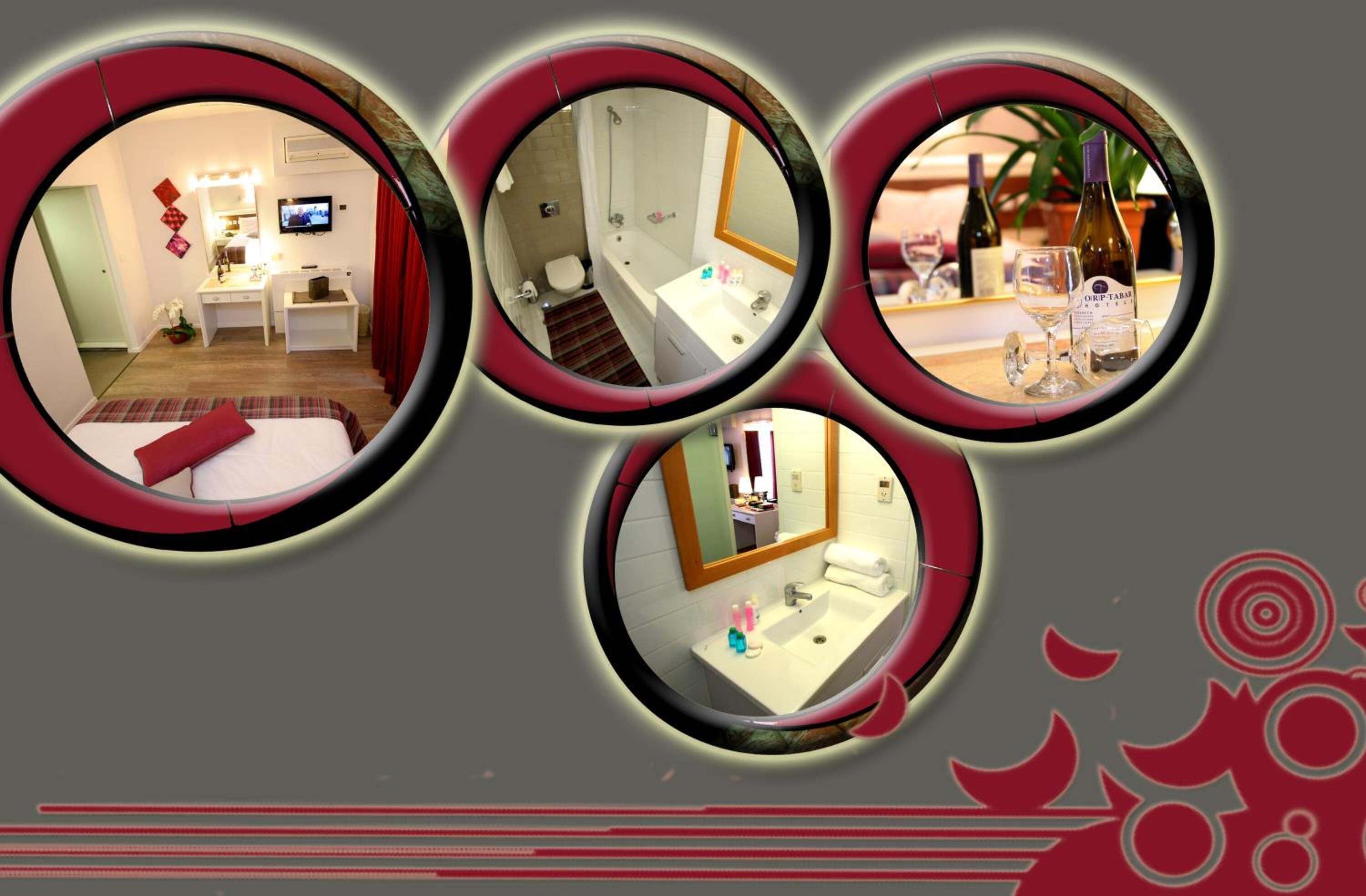 A hotel room with a bed, desk, and bathroom.
