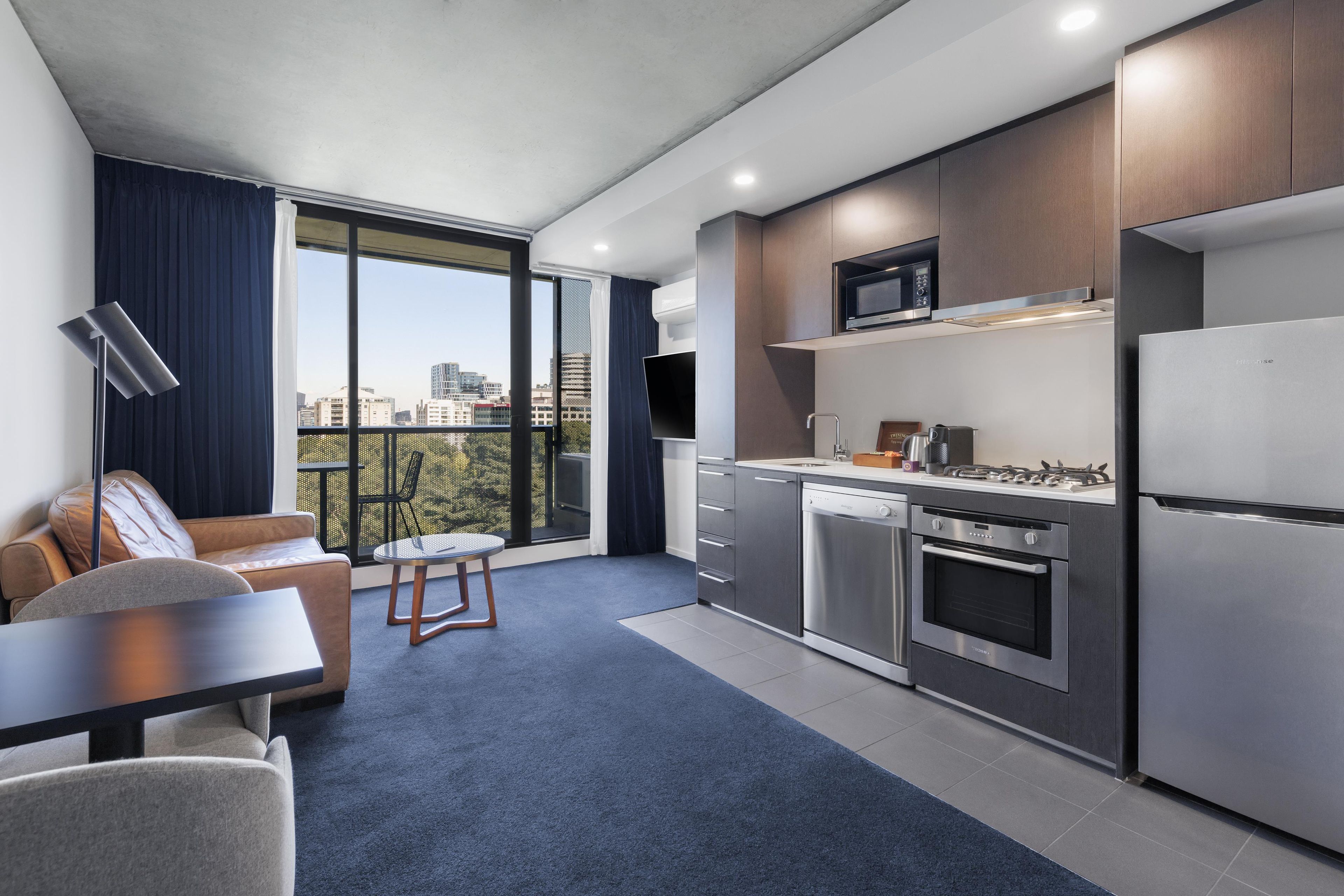 A modern kitchen with a built-in microwave, oven, and dishwasher.
