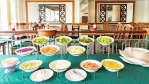 A buffet setup with various food dishes and a green tablecloth. - Viva Hotel Songkhla (Songkhla)