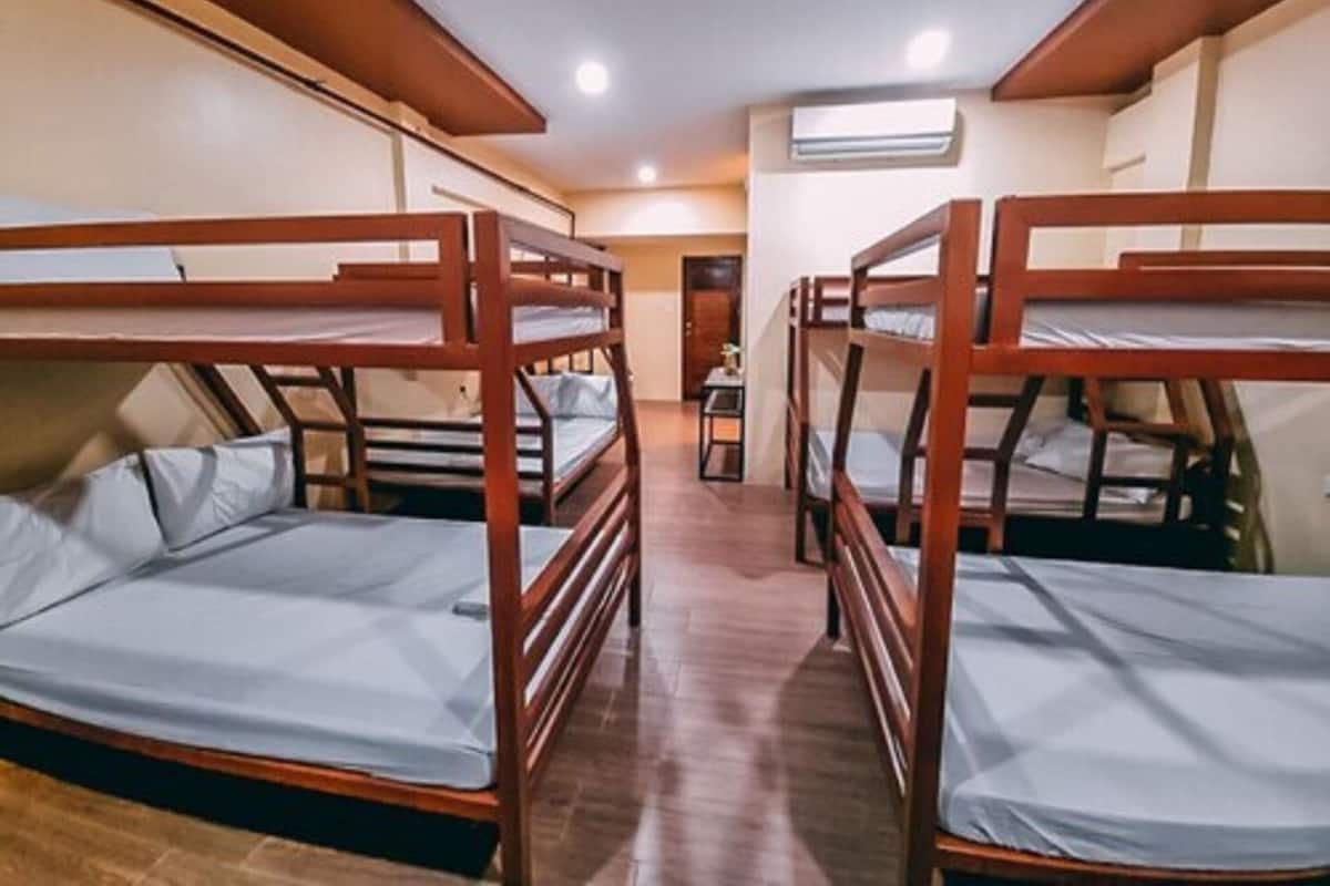 A room with bunk beds arranged in a row.