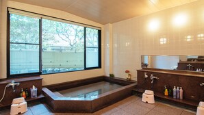 A modern bathroom with a large window, a bathtub, and a vanity with toiletries. - Koyasan Syukubo Kumagaiji (Koya)