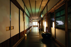 Un couloir doté de planchers en bois et de portes coulissantes traditionnelles de style japonais.