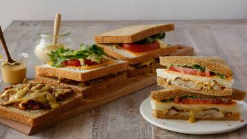 A variety of sandwiches on a wooden table.
