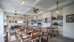 A spacious dining area with multiple tables and chairs, a pool table, and various wall decorations. - Paras Paros Marina Lodge (Serangan)