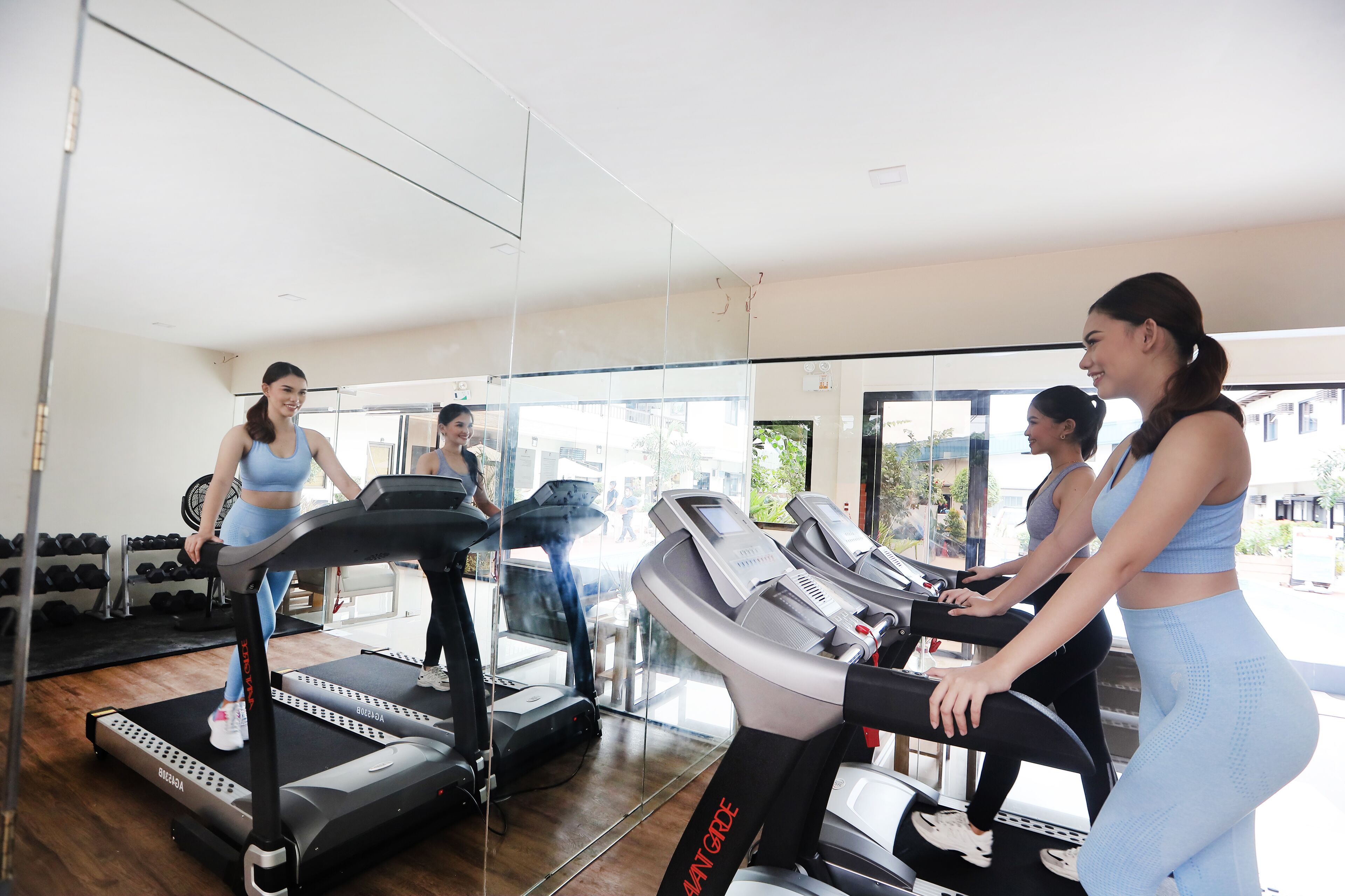 A gym with treadmills and dumbbells.