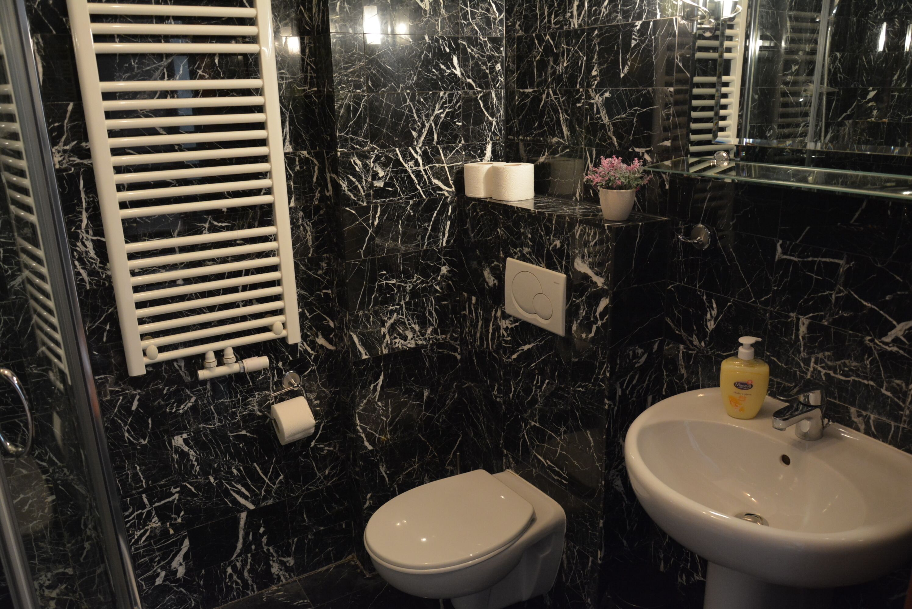 Un bagno con il water, un lavandino e un porta asciugamani.