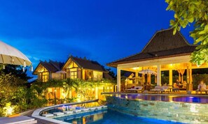 A resort with a swimming pool, a covered outdoor area with lounge chairs, and traditional-style buildings. - BoHo Bingin Beach (Pecatu)