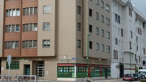 A multi-story hotel with a ground-level restaurant and a visible bike parking area. - Hotel Campus (Burgos)