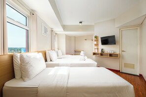 A hotel room with two beds, a TV, a shelf with toiletries, and a window with a city view. - MySpace Hotel at BGC (Taguig)