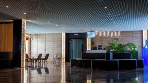 A modern lobby with a reception desk, seating area, and a polished floor. - Cross Resort Yerevan (Yerevan)