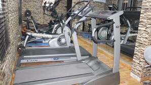A gym with treadmills, stationary bikes, and elliptical machines. - Avital Suites And Resort (Lagos)