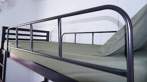 A bunk bed with a metal frame and green bedding. - Culture Club Backpackers - Hostel (Ko Pha-ngan)
